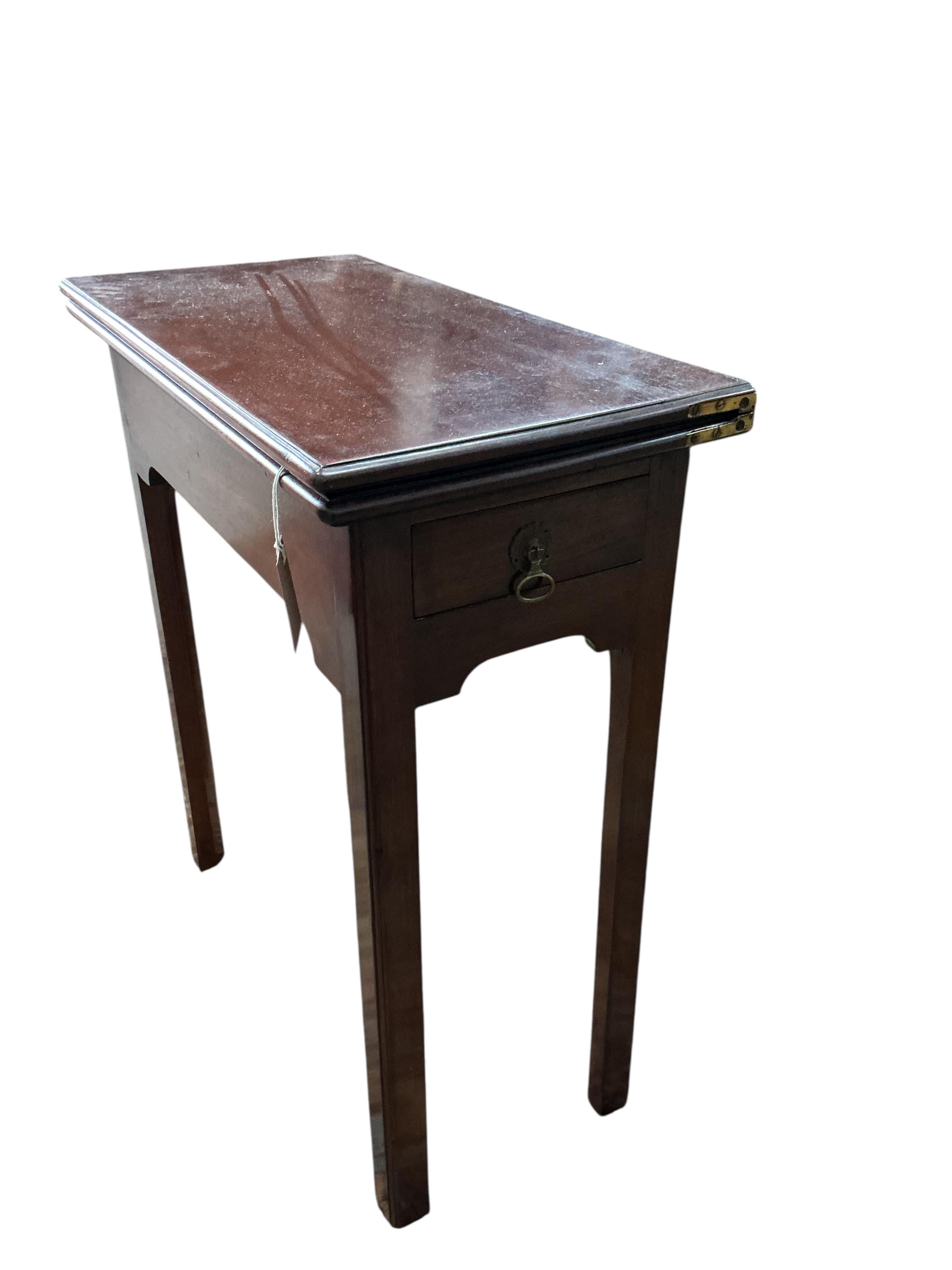 A George II rectangular mahogany folding tea table, width 63cm, depth 32cm, height 72cm